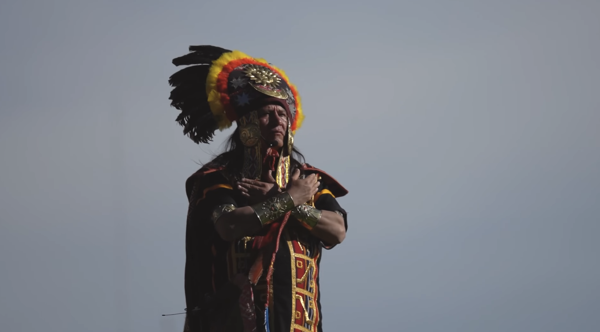 Performer in colorful Inca ceremonial costume with feathered headdress at Inti Raymi, Cusco | Ile Tours