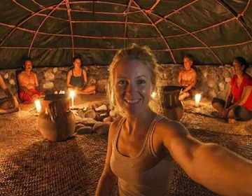Steam rising from the entrance of a traditional stone Temazcal in the Yucatan jungle | Ile Tours