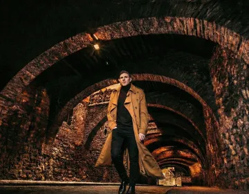 Stone arches of the subterranean road network in Guanajuato City lit by warm streetlights | Ile Tours