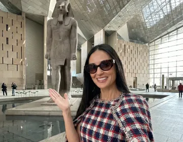 Affluent mature tourists receiving a private guided explanation inside the massive Grand Egyptian Museum | Ile Tours