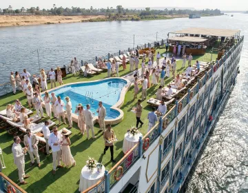 Modern 5-star Nile Cruise ship sailing near Aswan botanical gardens | Ile Tours