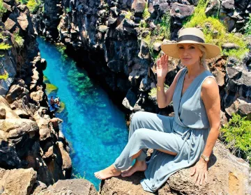 US traveler relaxing near the crystal-clear waters of Las Grietas on Santa Cruz Island | Ile Tours