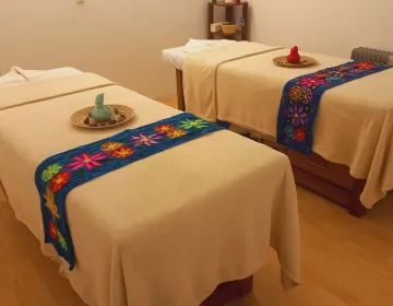 Spa massage room in Cusco with decorated tables and herbal therapy setup | Ile Tours