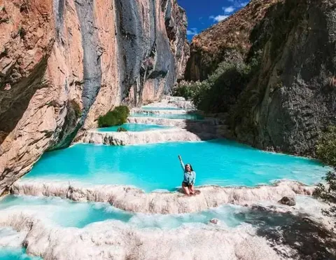 Woman enjoying the crystal clear turquoise waters of Millpu | Ile Tours